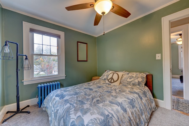 bedroom with ornamental molding, a ceiling fan, radiator, carpet, and baseboards