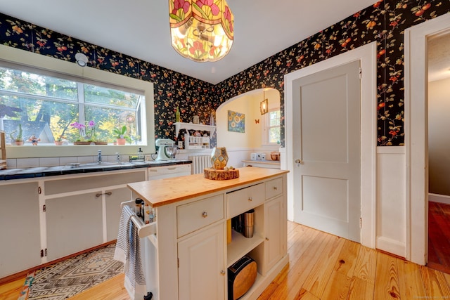 kitchen featuring wallpapered walls, open shelves, wood counters, white cabinetry, and light wood-type flooring