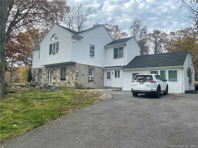 view of front of home with a garage and a front lawn