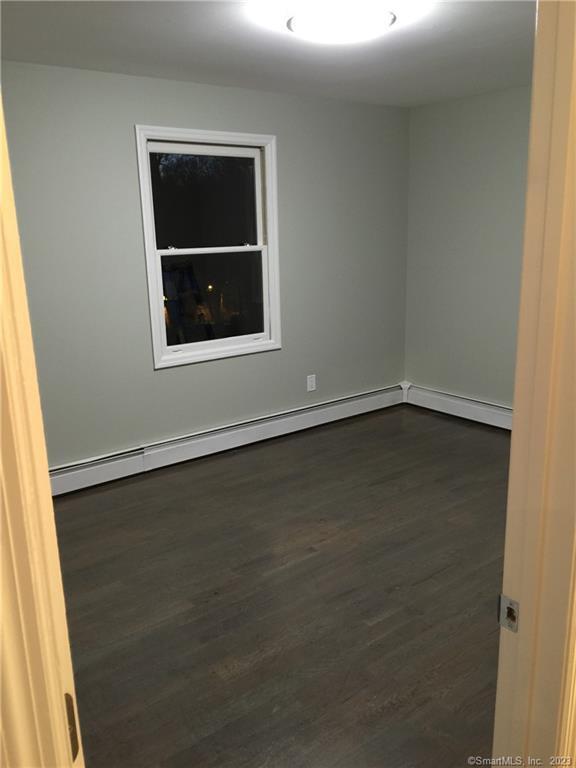 spare room featuring dark hardwood / wood-style floors