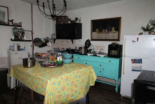 kitchen featuring white refrigerator, dark hardwood / wood-style floors, and blue cabinetry