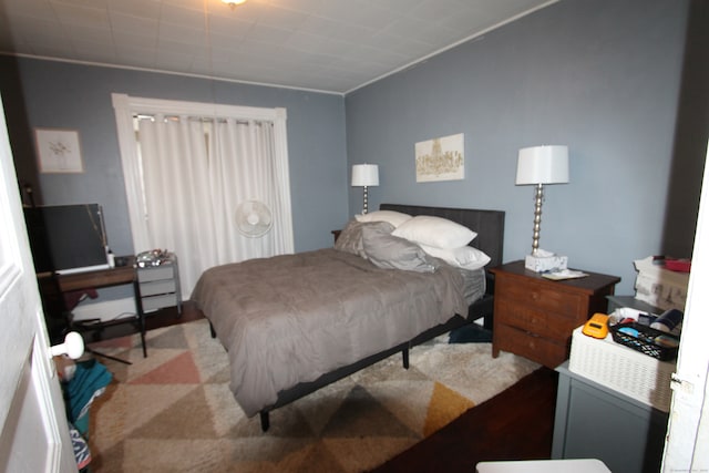 bedroom featuring light colored carpet and crown molding