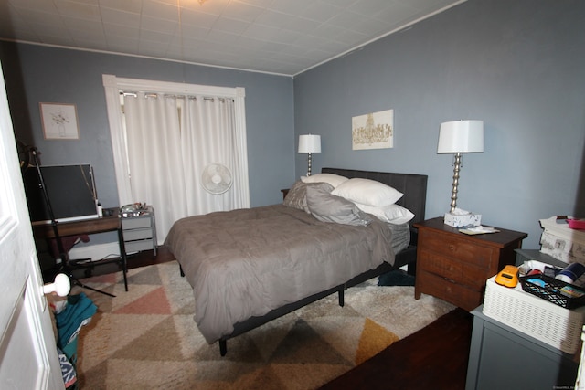 carpeted bedroom with ornamental molding