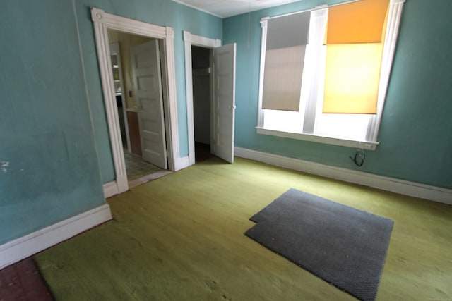 unfurnished bedroom featuring light carpet