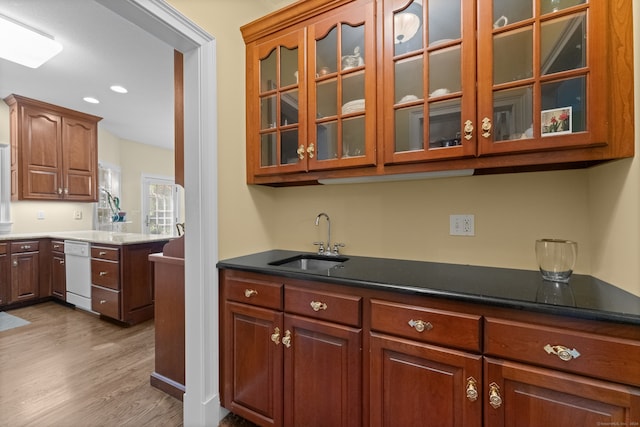 kitchen featuring light wood-type flooring, dishwasher, and sink