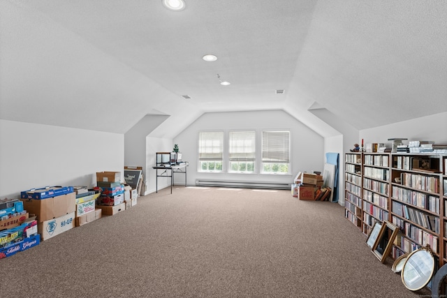 game room featuring vaulted ceiling, a textured ceiling, baseboard heating, and carpet floors