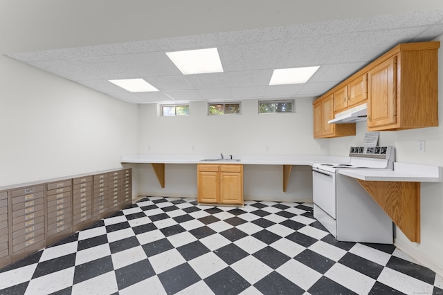 kitchen with sink, light brown cabinets, electric range, and a drop ceiling