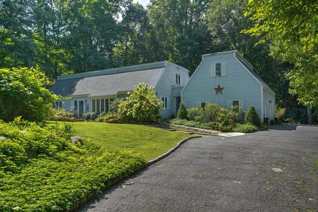 view of front facade with a front lawn and a garage