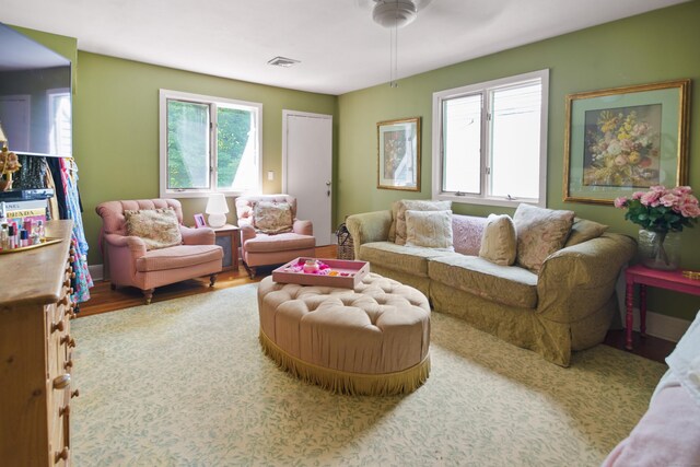 living room with hardwood / wood-style floors and ceiling fan