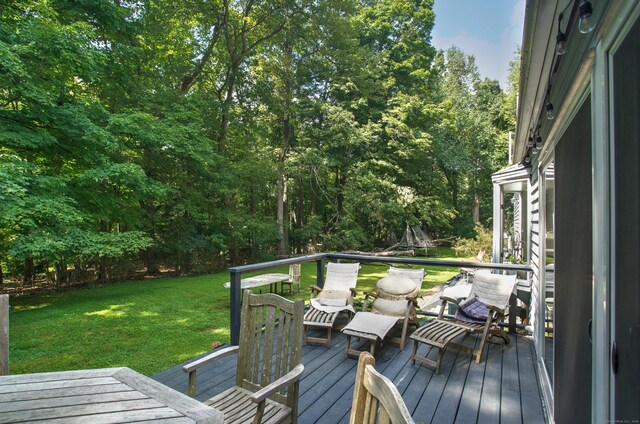 wooden terrace with a lawn