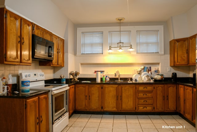 kitchen featuring decorative backsplash, electric stove, light tile patterned floors, decorative light fixtures, and sink