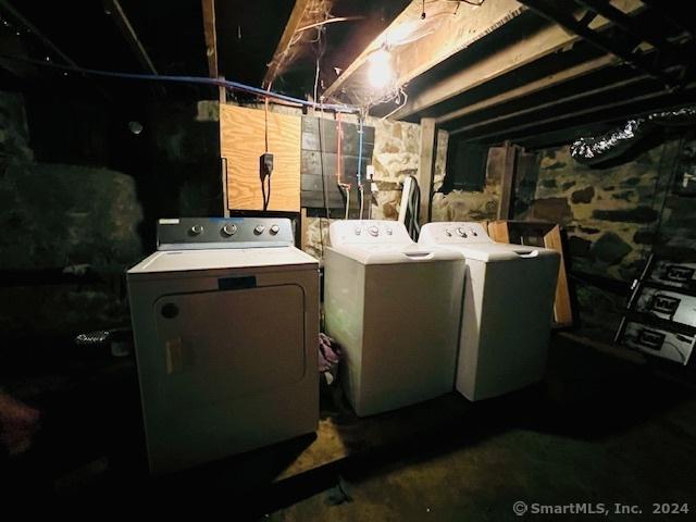 unfinished below grade area featuring independent washer and dryer