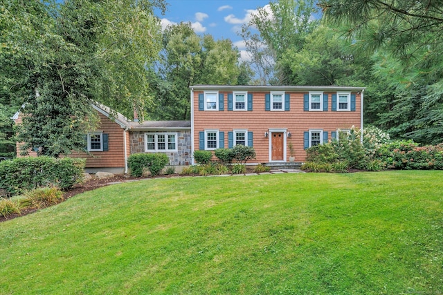 colonial-style house with a front lawn