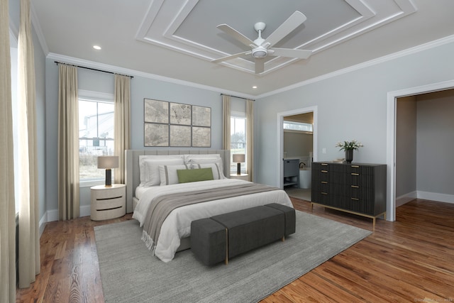 bedroom with multiple windows, wood-type flooring, ornamental molding, and ceiling fan