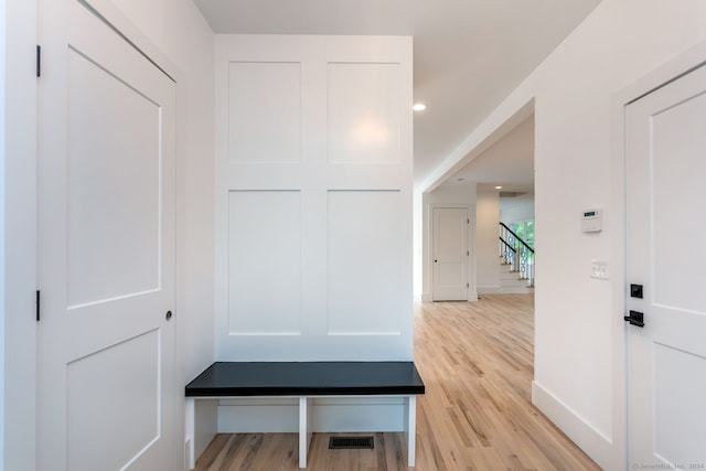 mudroom with light hardwood / wood-style flooring