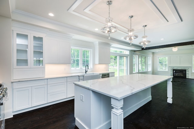 kitchen featuring pendant lighting, white cabinets, dark hardwood / wood-style flooring, and a kitchen island