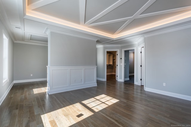 spare room with coffered ceiling, dark hardwood / wood-style flooring, and crown molding