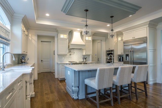 kitchen featuring white cabinets, backsplash, dark hardwood / wood-style floors, and premium range hood