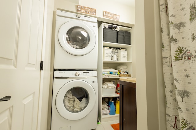 clothes washing area with stacked washer / drying machine