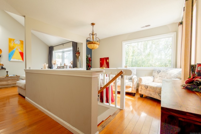 bedroom with vaulted ceiling and light wood-type flooring