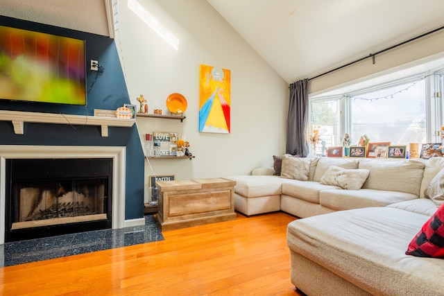 living room with vaulted ceiling and hardwood / wood-style floors