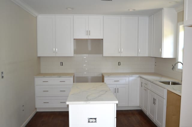 kitchen featuring a center island, white cabinetry, sink, dark hardwood / wood-style floors, and decorative backsplash