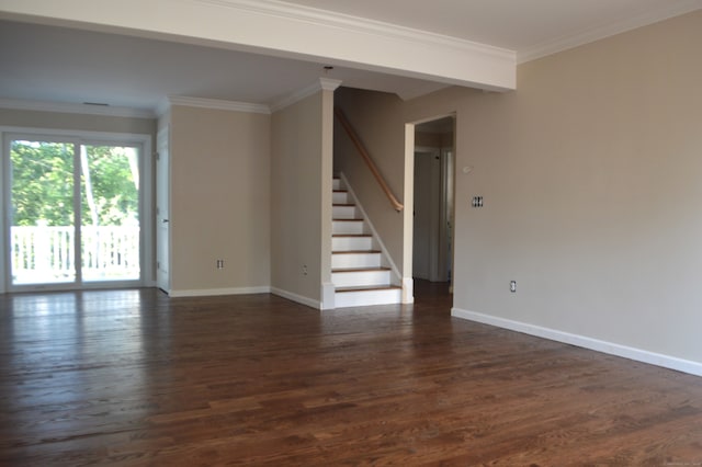 spare room featuring dark wood-type flooring and ornamental molding