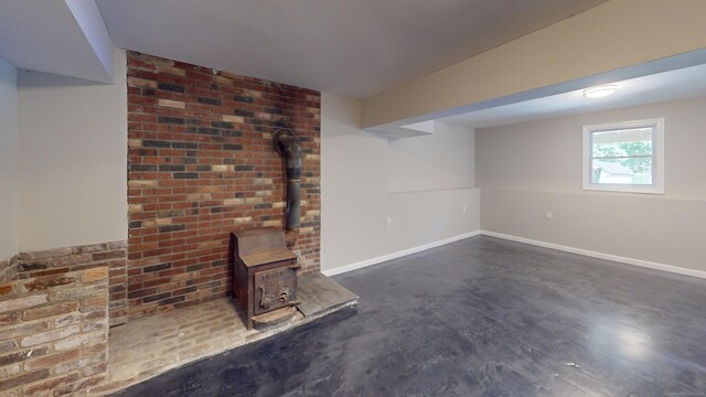 unfurnished living room with a wood stove