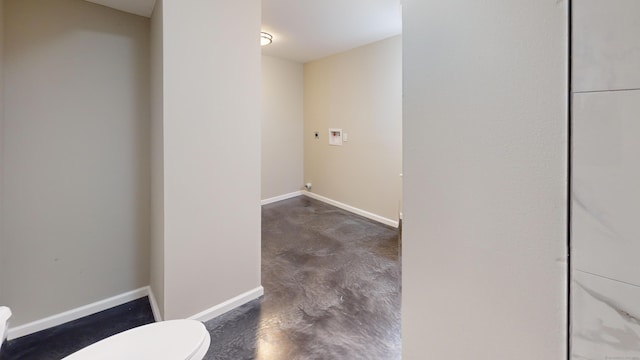 interior space with concrete flooring and toilet