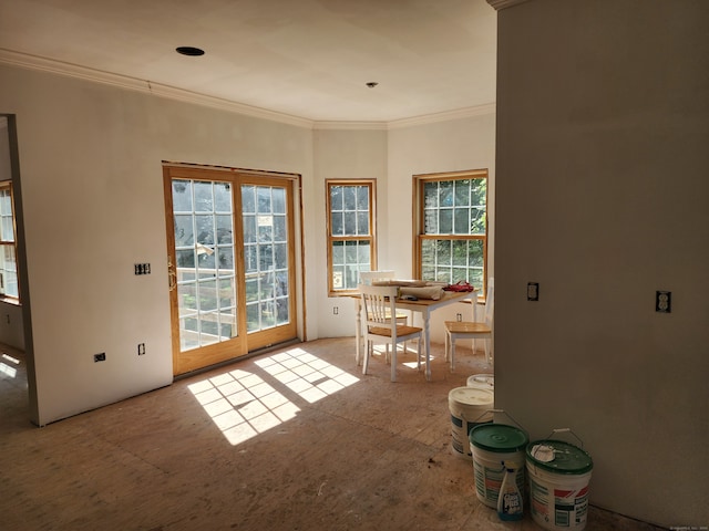 doorway with a healthy amount of sunlight and ornamental molding