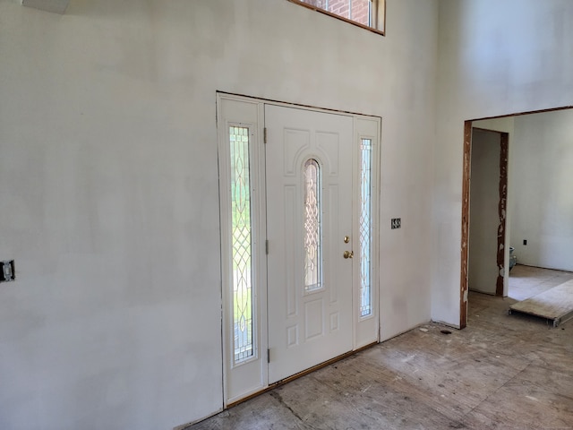 foyer entrance with a towering ceiling