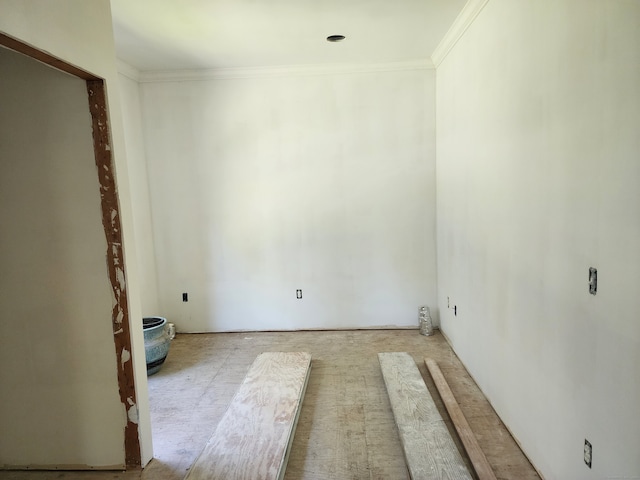 unfurnished room featuring crown molding