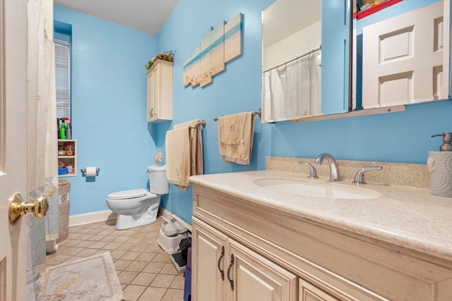 bathroom featuring vanity, toilet, and tile patterned flooring