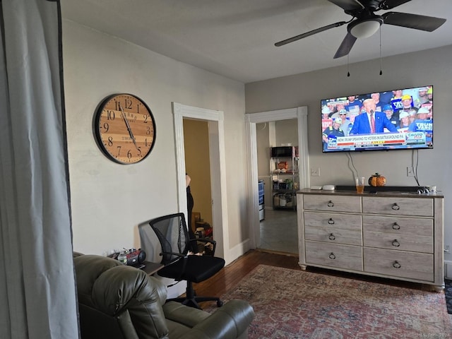 living room with a ceiling fan and dark wood finished floors