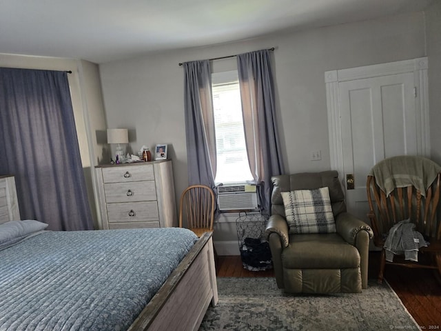 bedroom featuring dark wood finished floors and baseboards