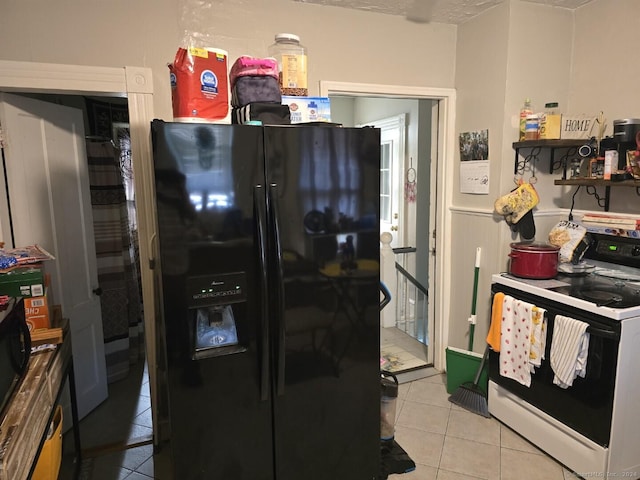 kitchen with tile patterned flooring, black refrigerator with ice dispenser, and electric range oven