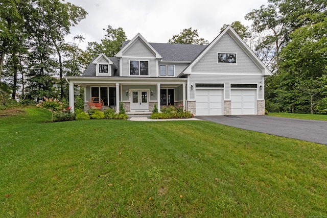 craftsman house with a garage, a front lawn, and a porch