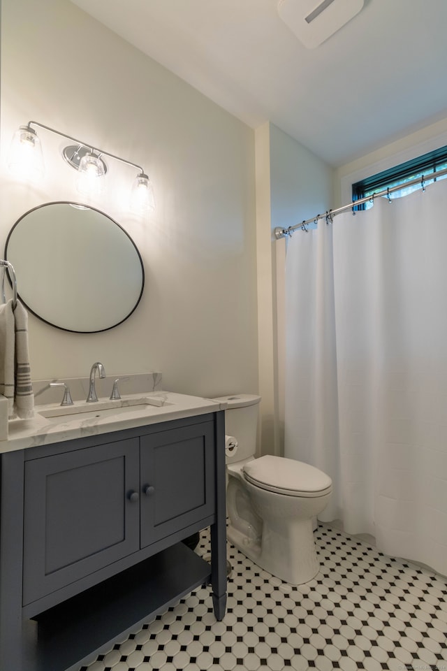 bathroom with toilet, vanity, a shower with shower curtain, and tile patterned flooring