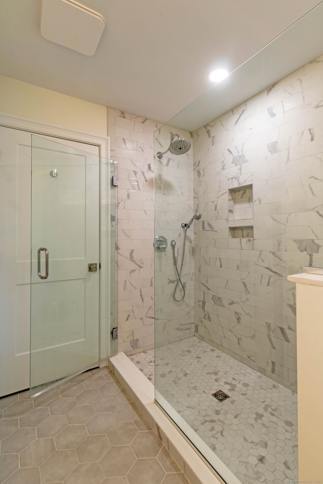 bathroom featuring an enclosed shower and tile patterned flooring