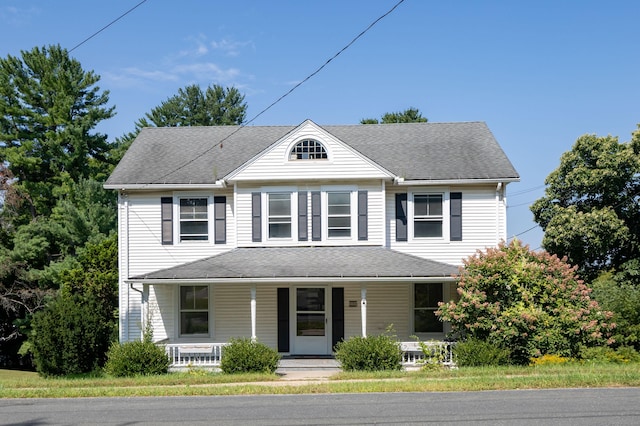 view of front of home with a porch and roof with shingles