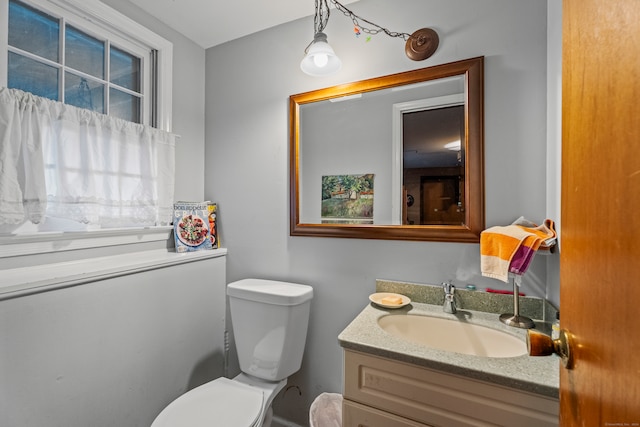 bathroom featuring toilet and vanity