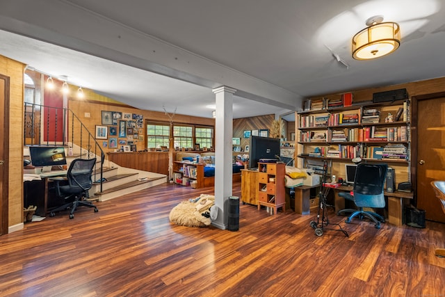 office space with wood walls, beamed ceiling, wood-type flooring, and ornate columns