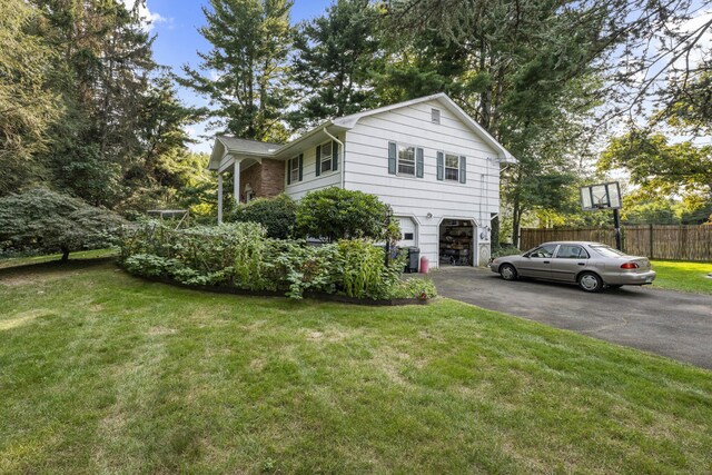110 William St, Norwalk, CT 06851 - view of front of property with a garage and asphalt driveway