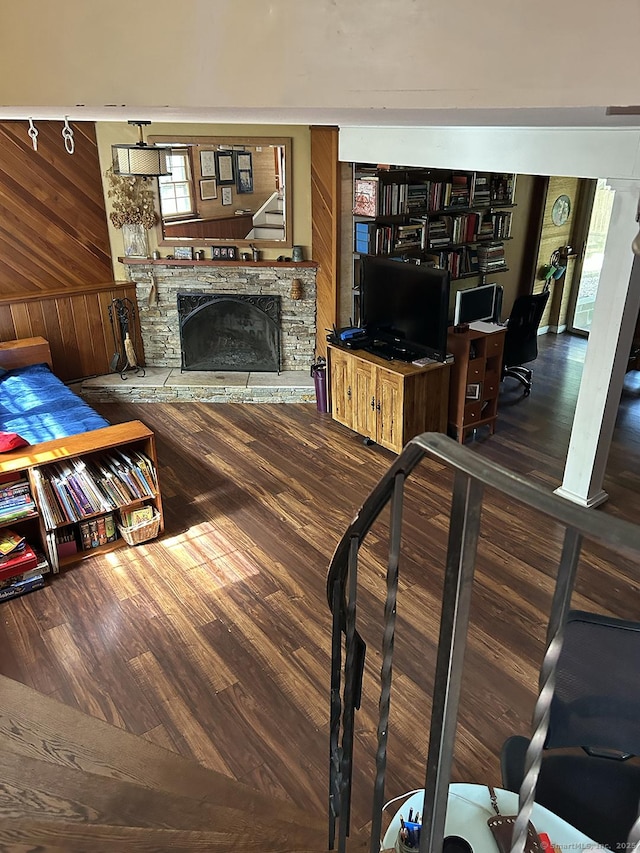 110 William St, Norwalk, CT 06851 - living room with wood walls, wood finished floors, a stone fireplace, track lighting, and an office area