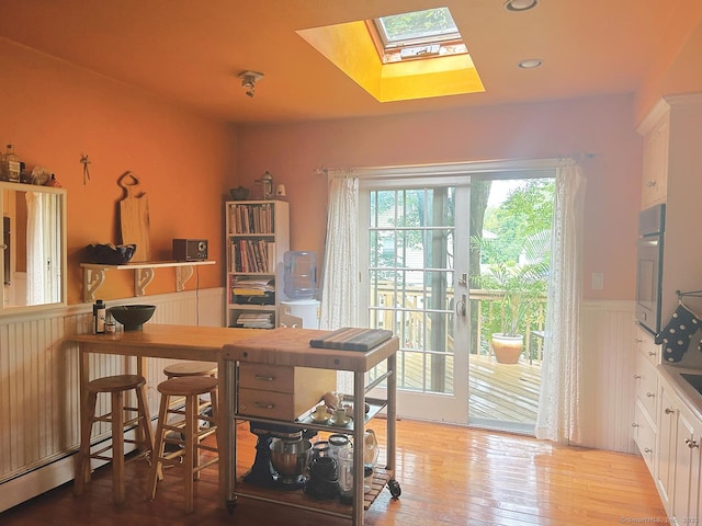 110 William St, Norwalk, CT 06851 - office with wainscoting, a skylight, and light wood finished floors
