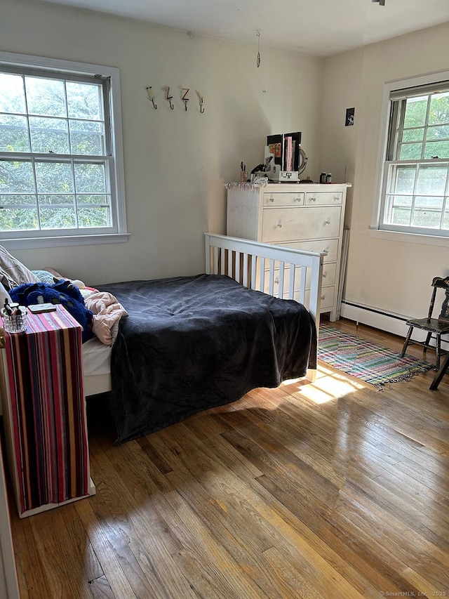 110 William St, Norwalk, CT 06851 - bedroom with a baseboard heating unit and wood finished floors