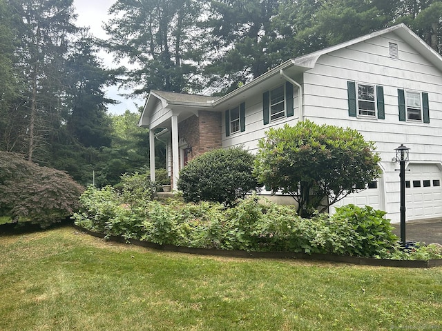 110 William St, Norwalk, CT 06851 - view of home's exterior featuring a yard and an attached garage