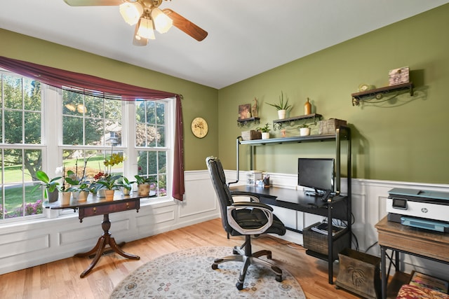 home office featuring light hardwood / wood-style floors and ceiling fan