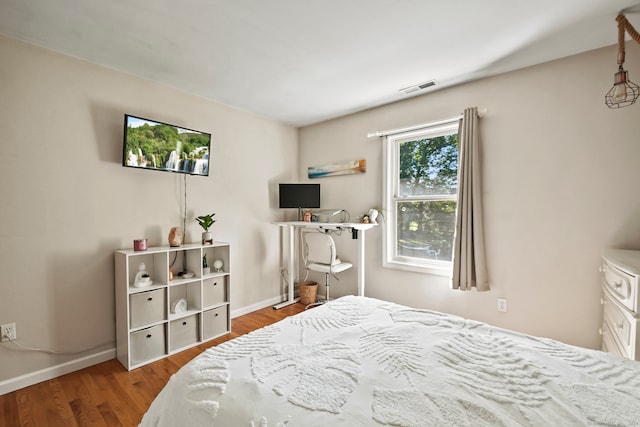 bedroom with hardwood / wood-style flooring