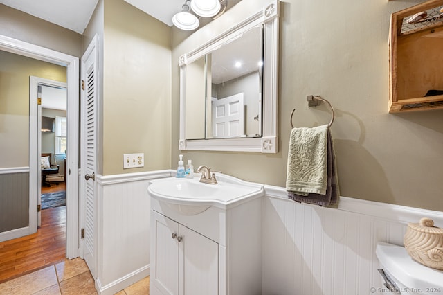 bathroom with vanity, hardwood / wood-style floors, and toilet